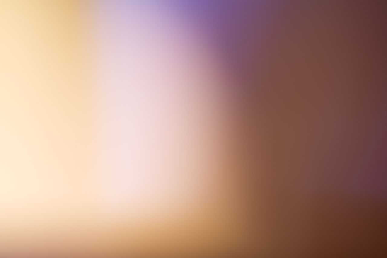 A soothing abstract blurred gradient background with warm tones.